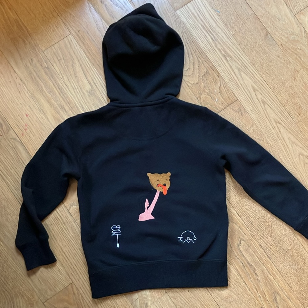 BDDW lady holding a bear head hoodie!